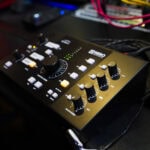 A close up of a black control panel on a desk.